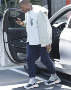 Kanye West wearing Adidas Yeezy Boosts 700 Wave Runner shoes